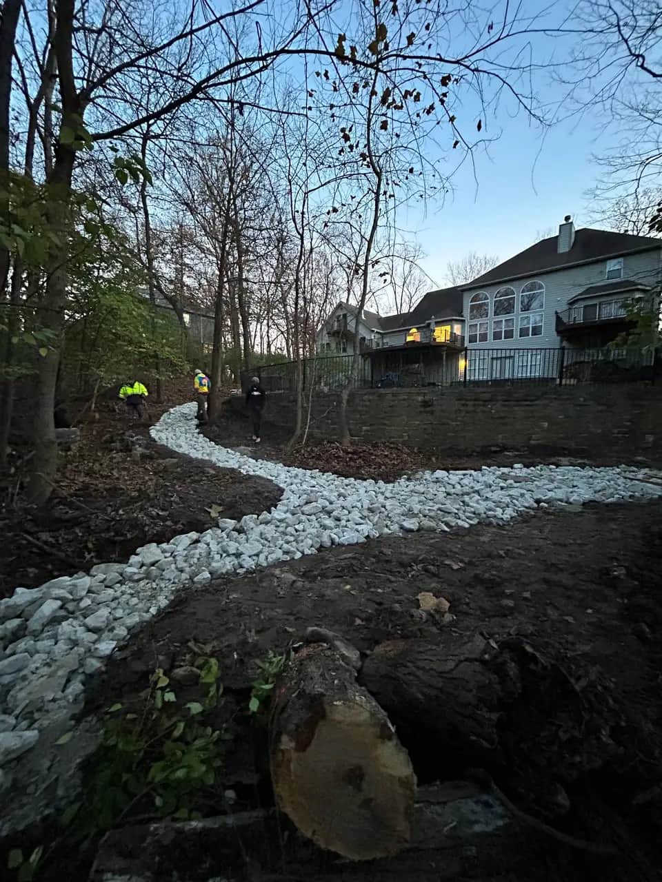 Winding dry creek bed of white stone
