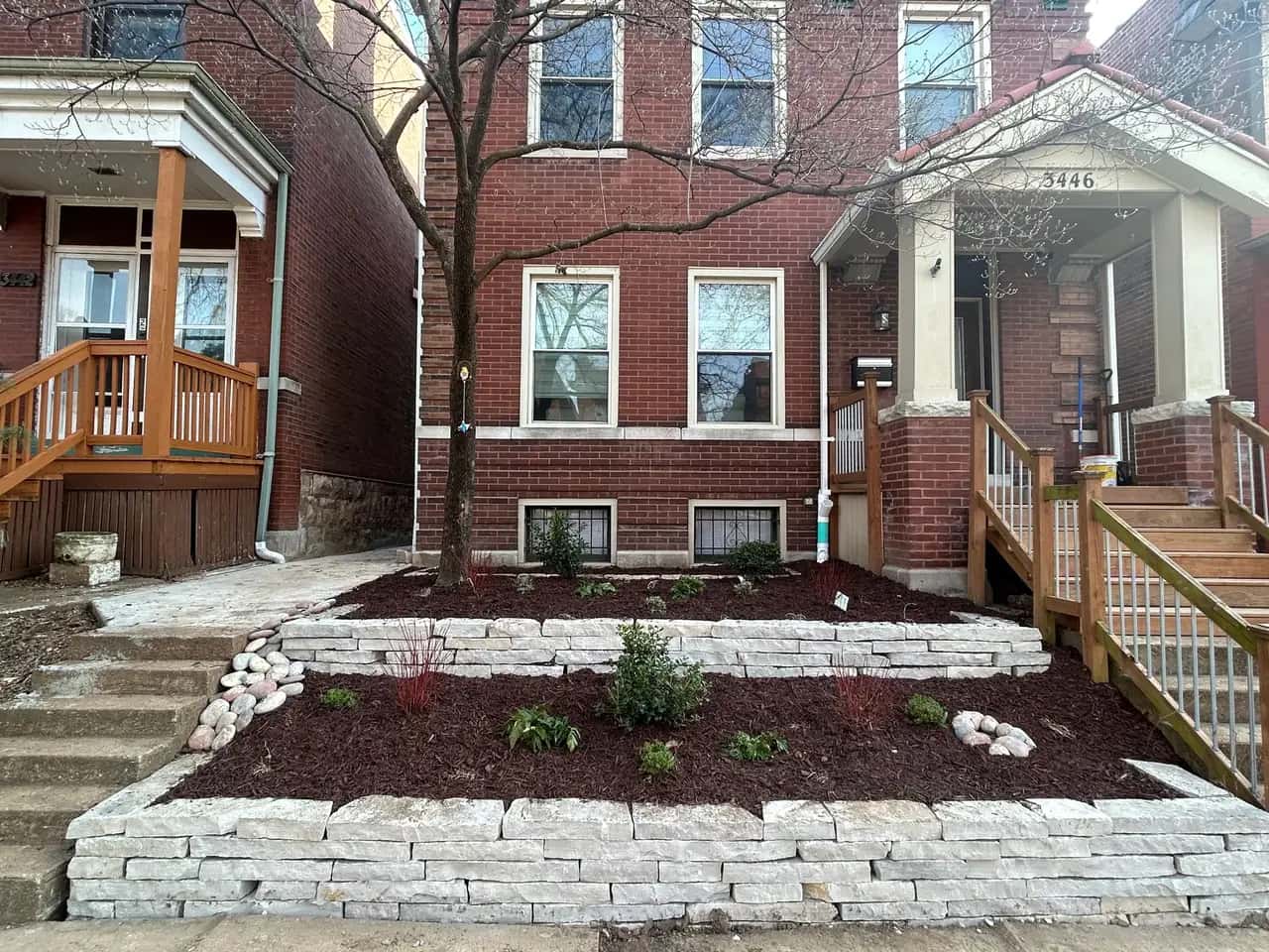 Stone retaining wall around a front garden bed