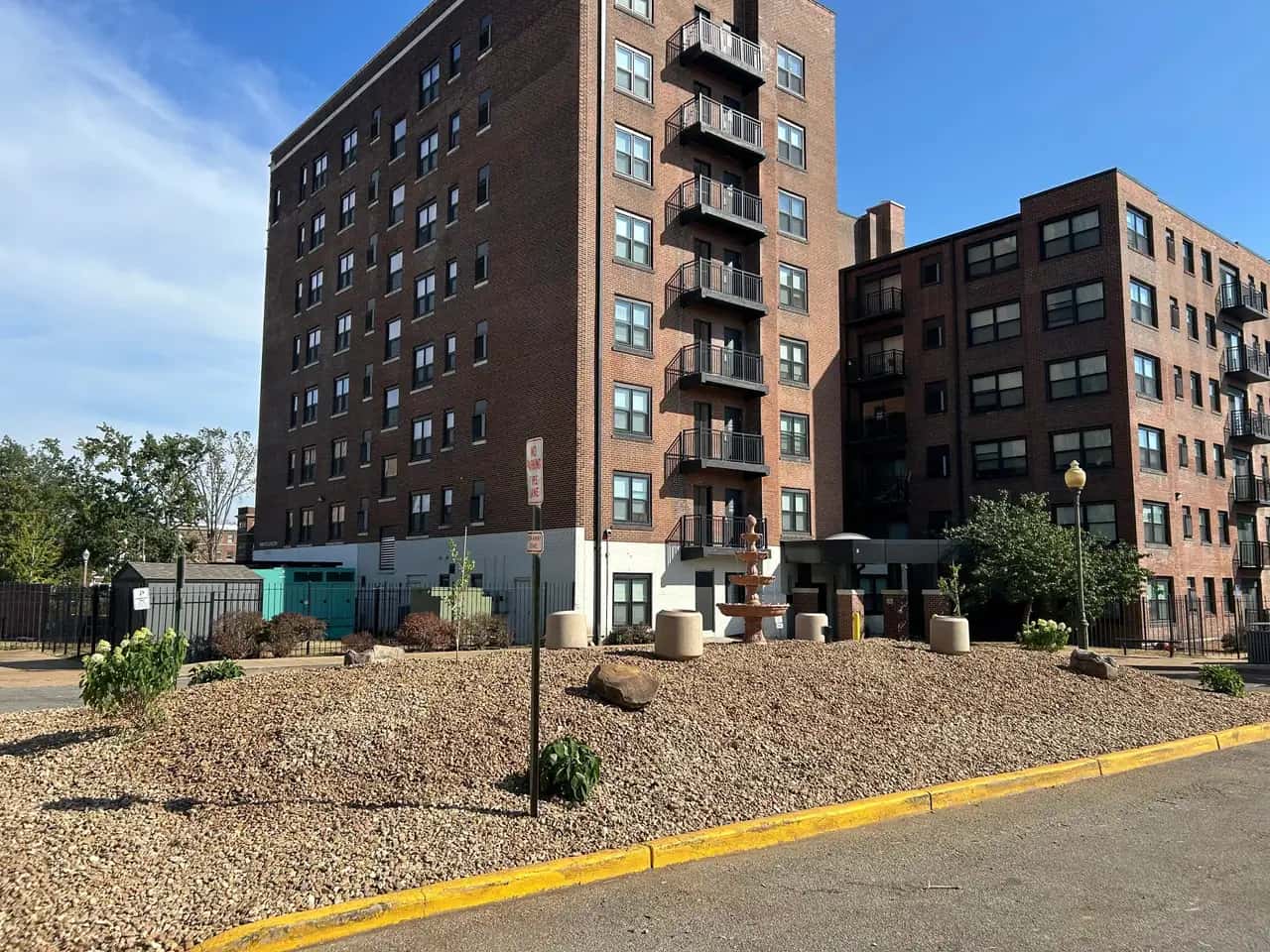 Apartment building landscape bed with shrubs and gravel