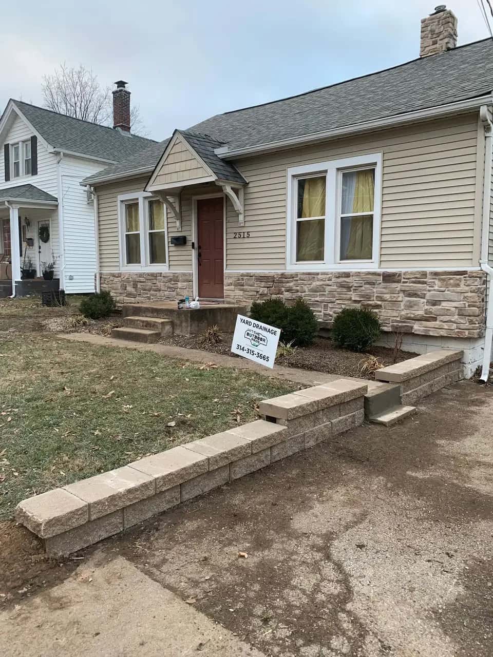 Front yard with a block retaining wall and walkway