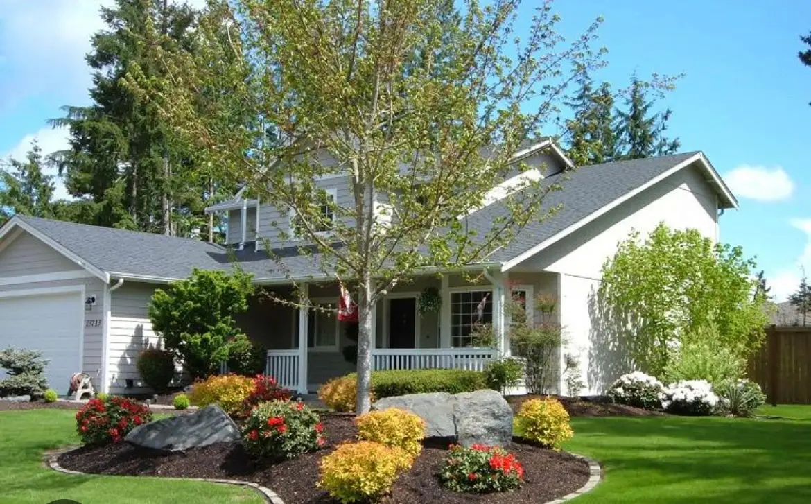 Front yard with colorful shrubs and boulder accents