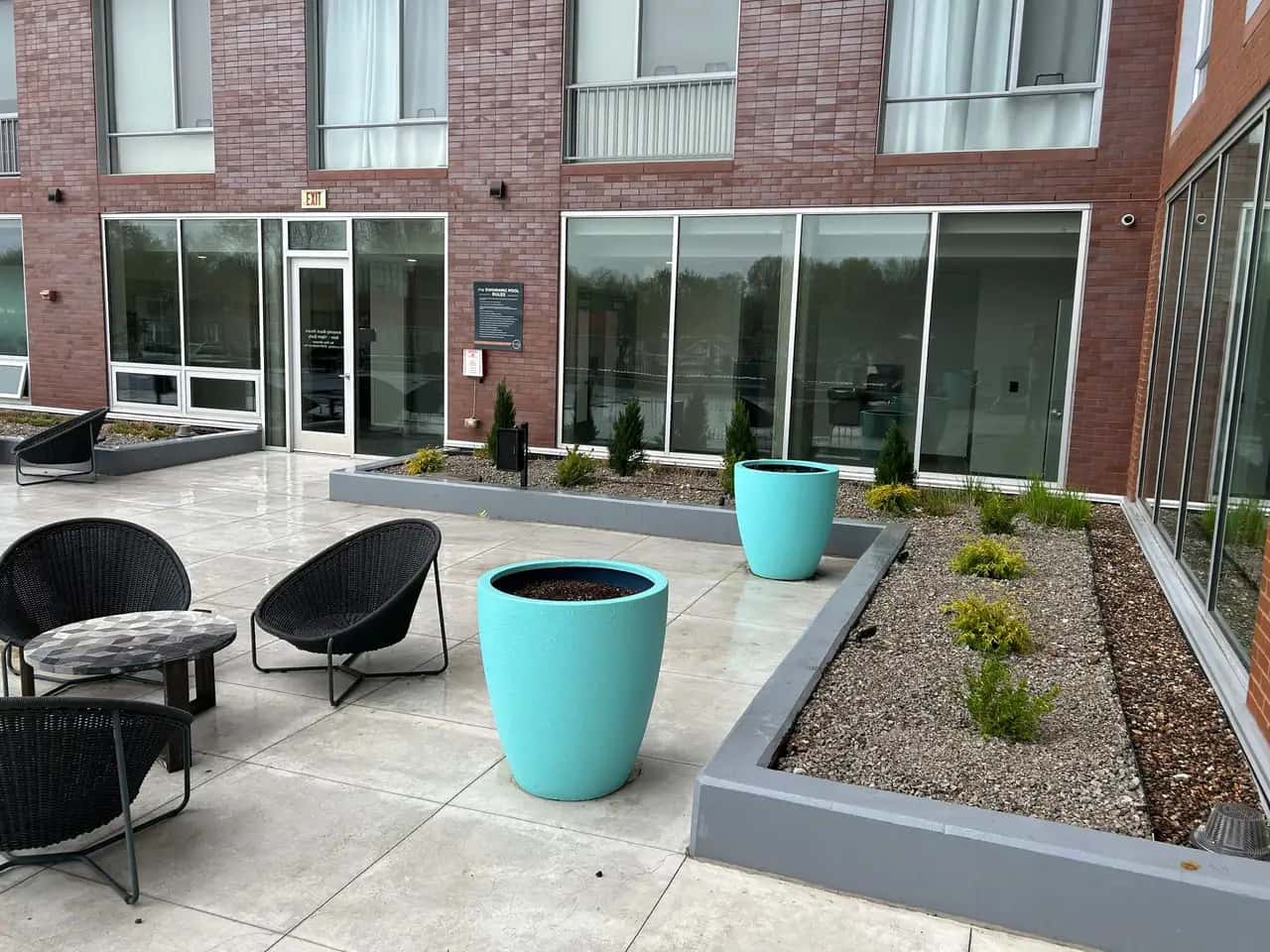 Commercial patio with raised planters and turquoise pots